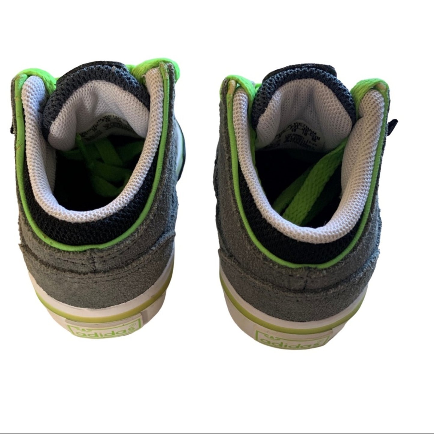 Pair of gray sneakers with green accents on a white background