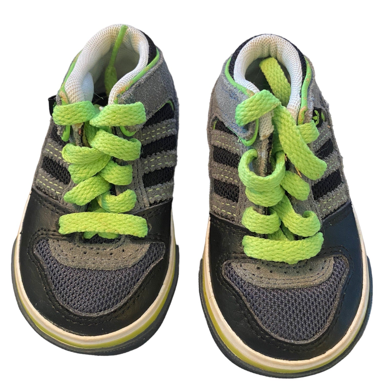 Pair of children's sneakers with green laces on a white background