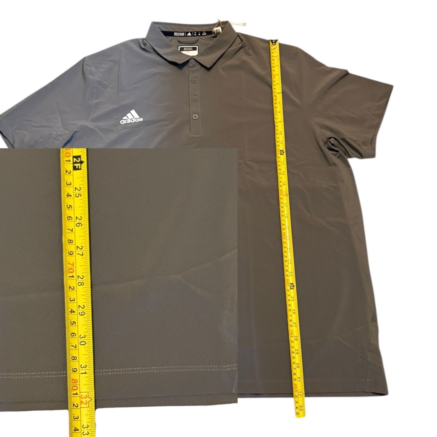Gray Adidas polo shirt with a measuring tape for size reference on a white background