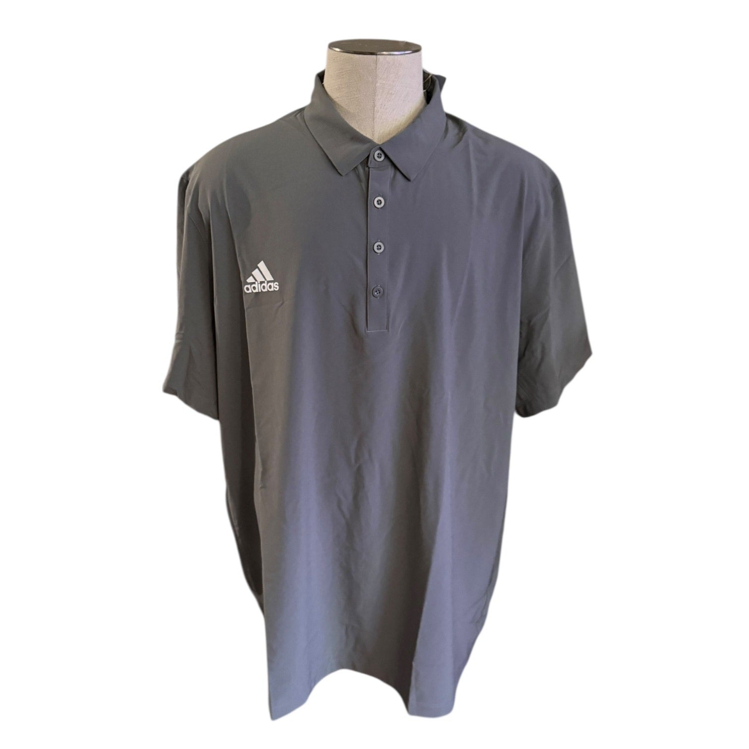 Front of Gray Adidas polo shirt on a mannequin against a white background
