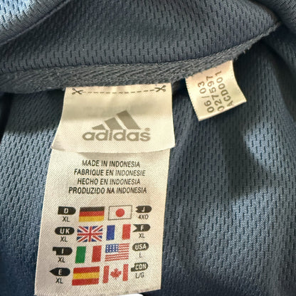 Adidas label on a sports shirt with size chart