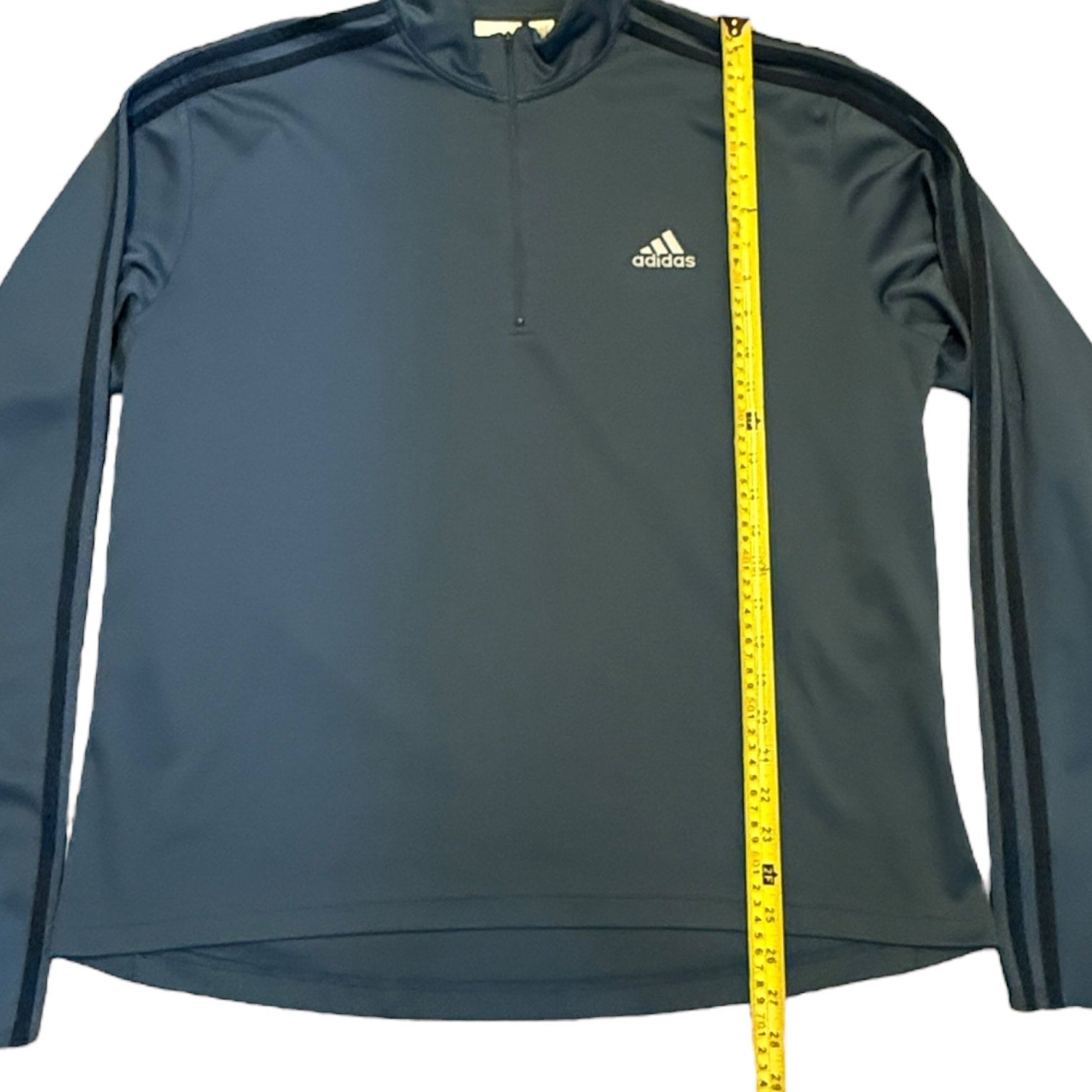 Gray Adidas sweatshirt with a measuring tape on a white background