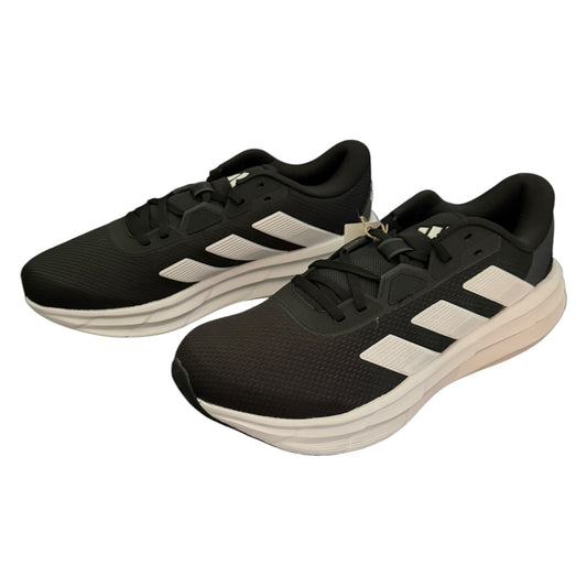 A pair of black Adidas running shoes with white three-stripes and a thick white midsole, shown on a plain white background.