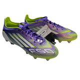 Front side of Purple and green soccer cleats with a visible brand tag on a white background