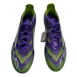Front of Purple and green soccer cleats on a white background
