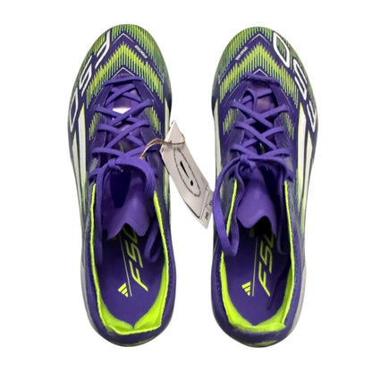 Top of Purple and green athletic shoes with a keychain on a white background