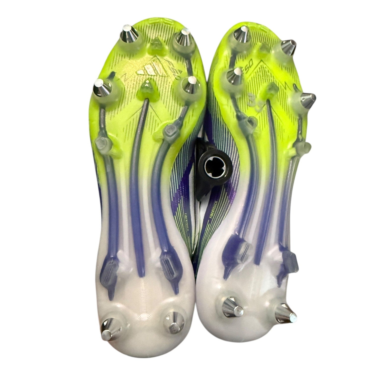Bottom of a Pair of soccer cleats with green and purple design on a white background