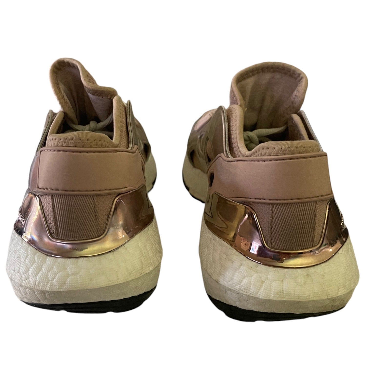 Back view of rose gold sneakers on a white background