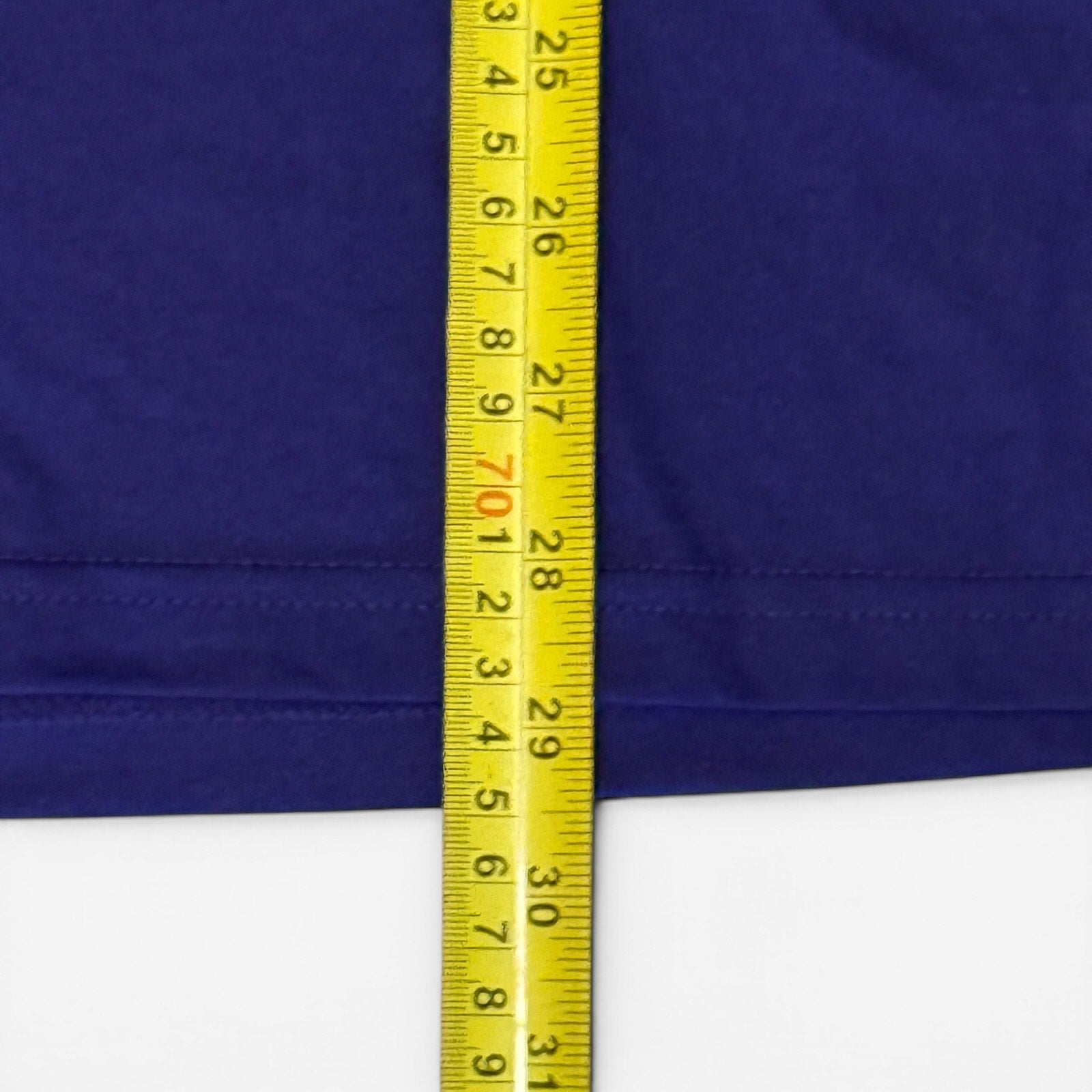 Yellow measuring tape on a purple fabric background