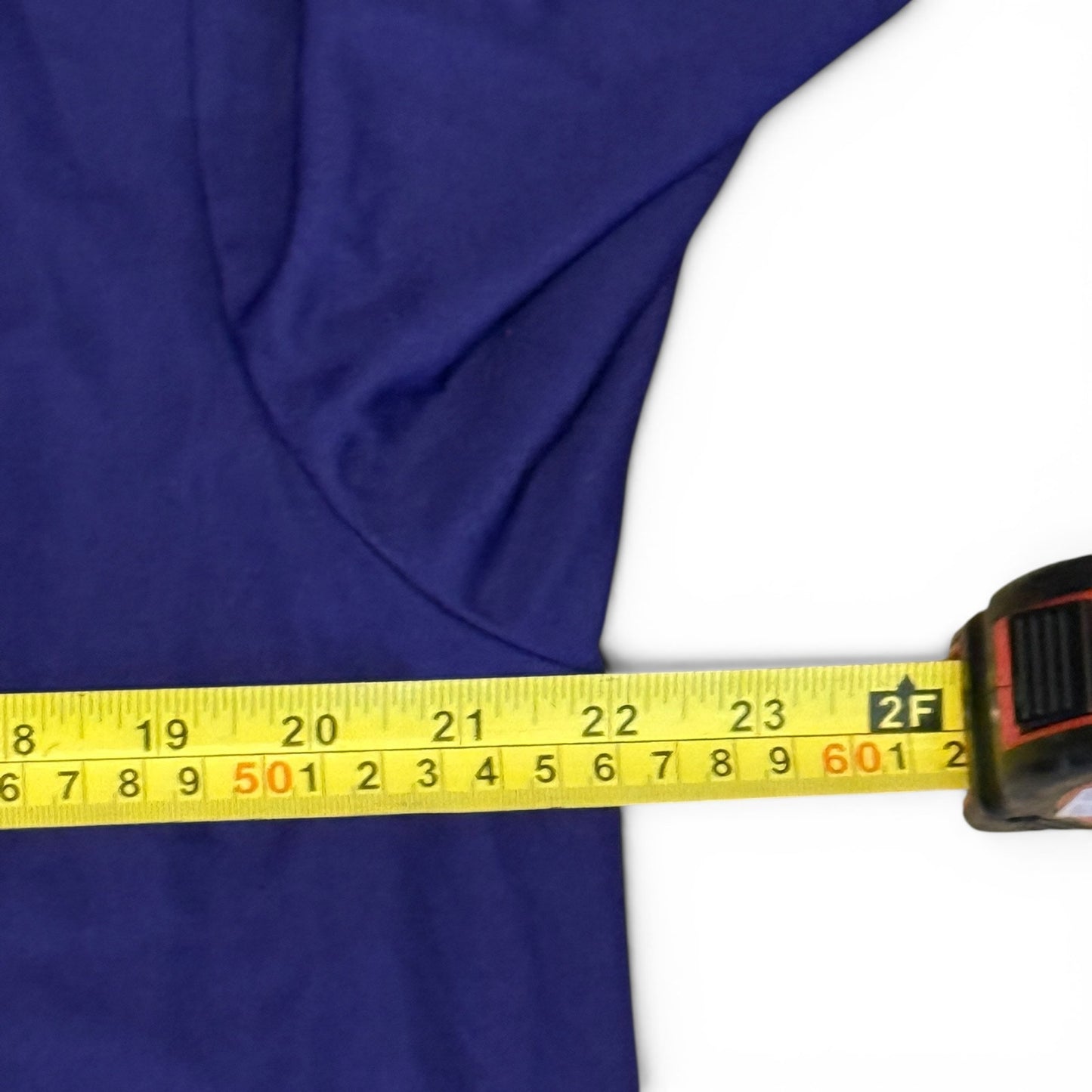 Yellow measuring tape on a purple fabric background