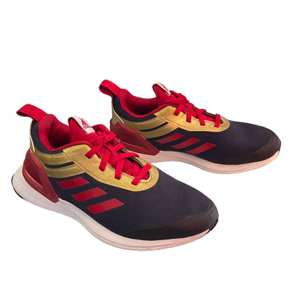 Pair of Adidas sneakers with red, gold, and black design on a white background