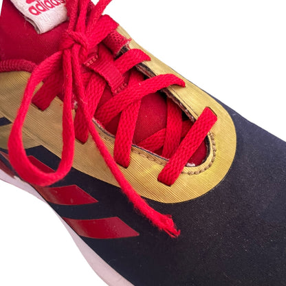 Close-up of a red-lace with damage on sneaker with a visible Adidas logo on a white background