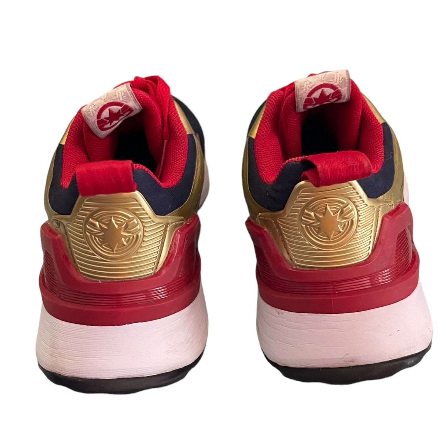 Back of sneakers with a prominent brand logo on a white background
