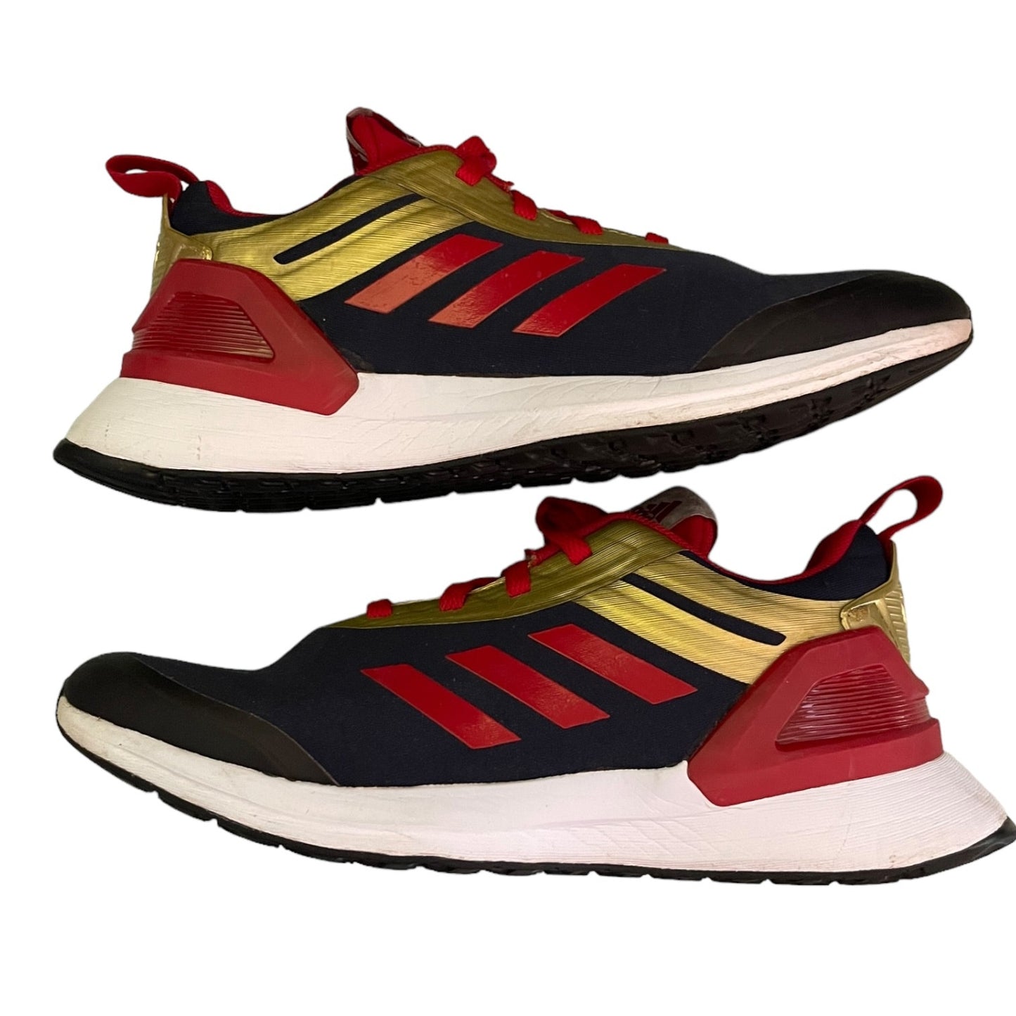 Pair of Adidas sneakers with red, gold, and black design on a white background