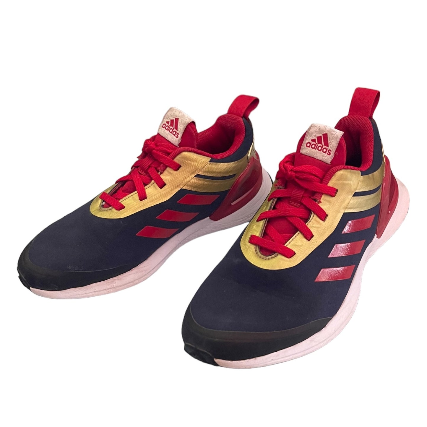 Pair of Adidas sneakers with red, black, and gold design on a white background
