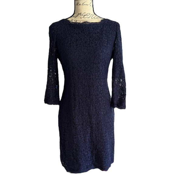 Front of Navy blue lace dress on a mannequin against a white background