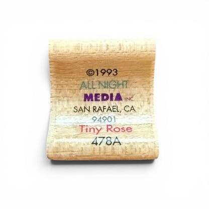 Wooden stamp with text 'All Night Media Inc' and address on a white background