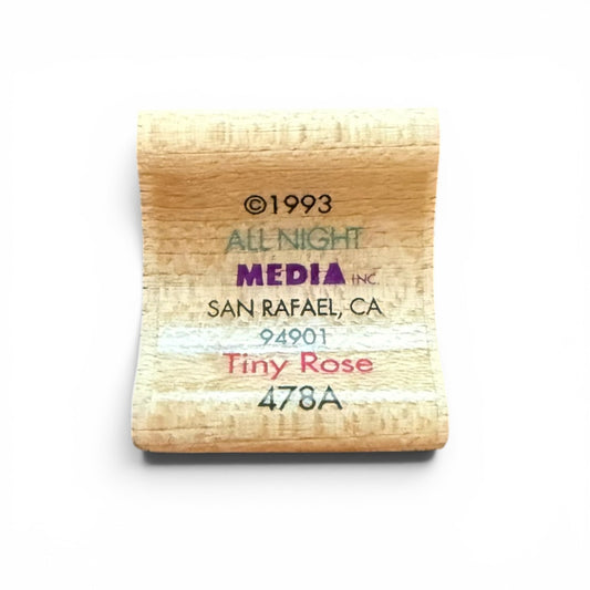 Wooden stamp with text 'All Night Media Inc' and address on a white background