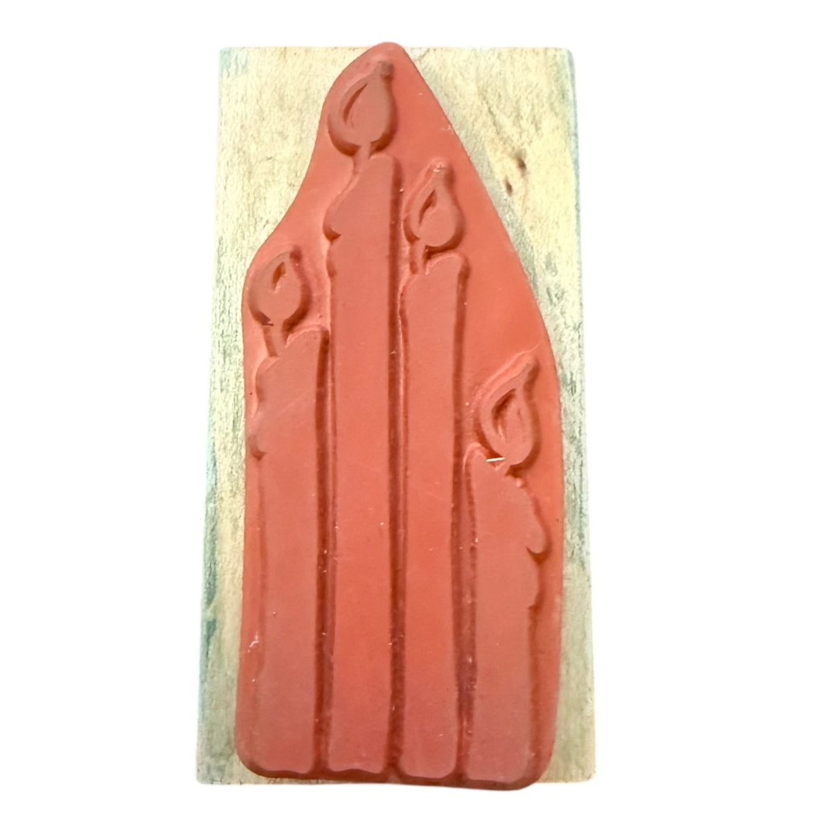 A rubber stamp mounted on a rectangular light-colored wooden block against a plain white background.