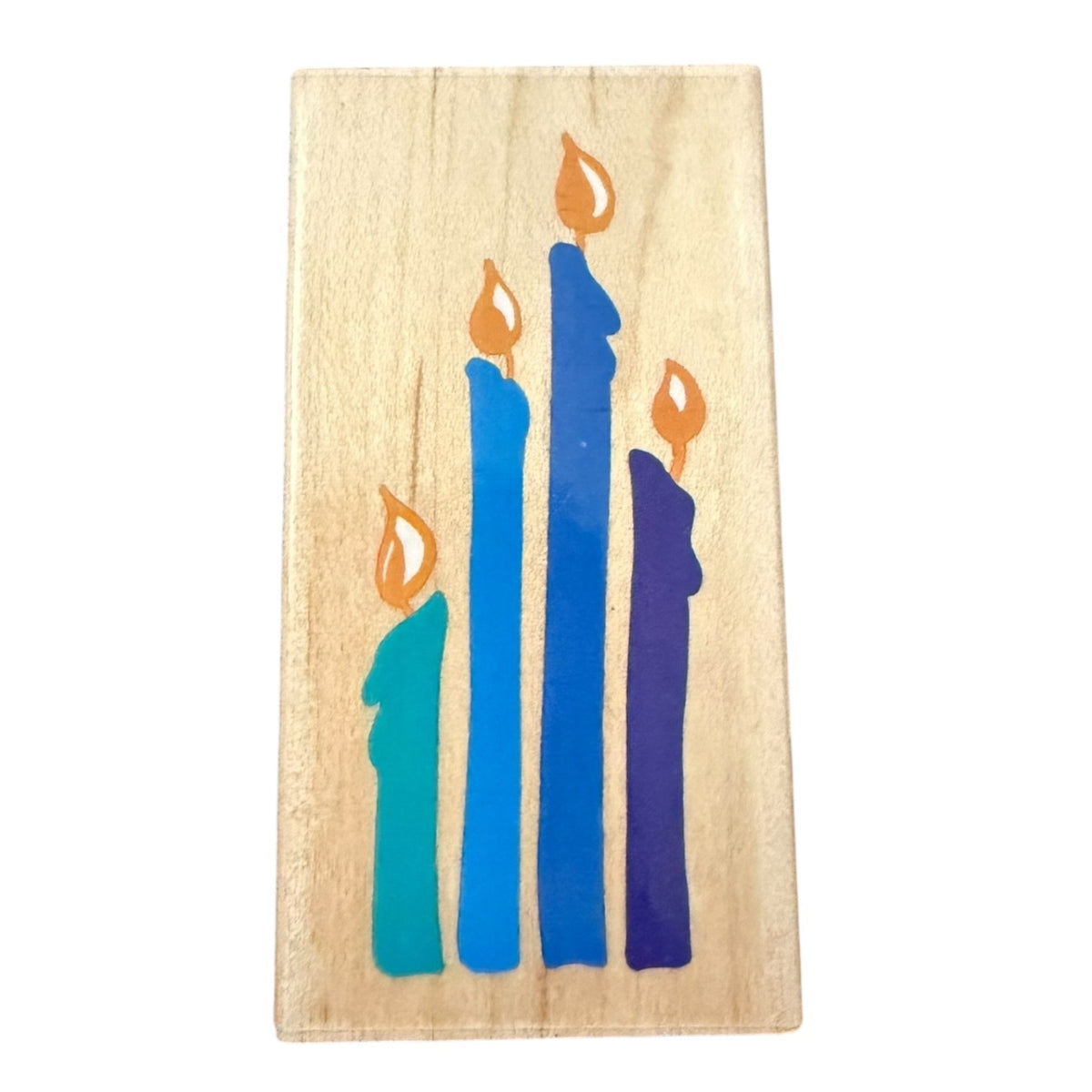 A rectangular wooden stamp featuring an illustration of four lit candles on a white background