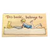 Illustrated book cover with a child and bear reading, featuring 'This book belongs to' text.