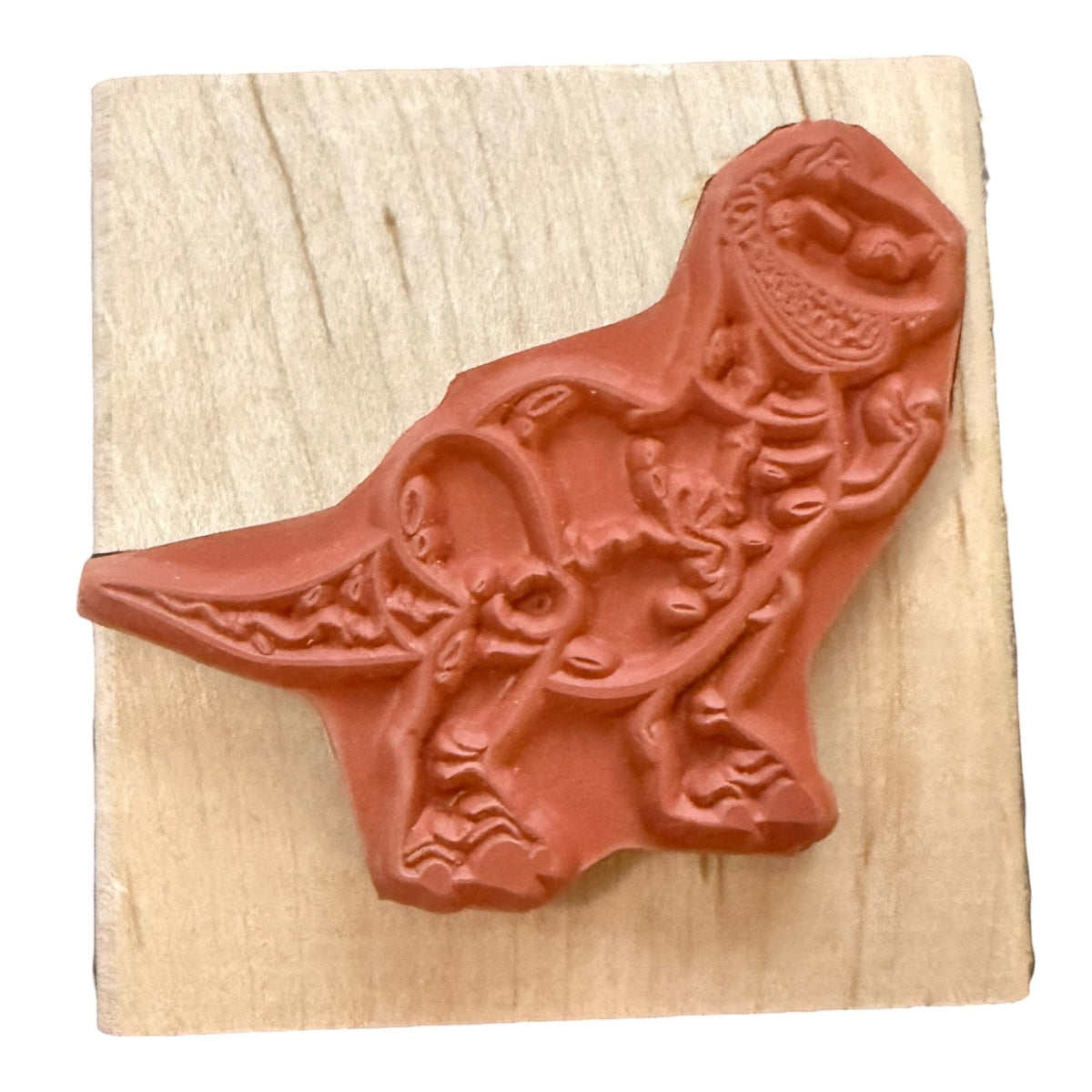 Rubber stamp on a wood block with a white background. 