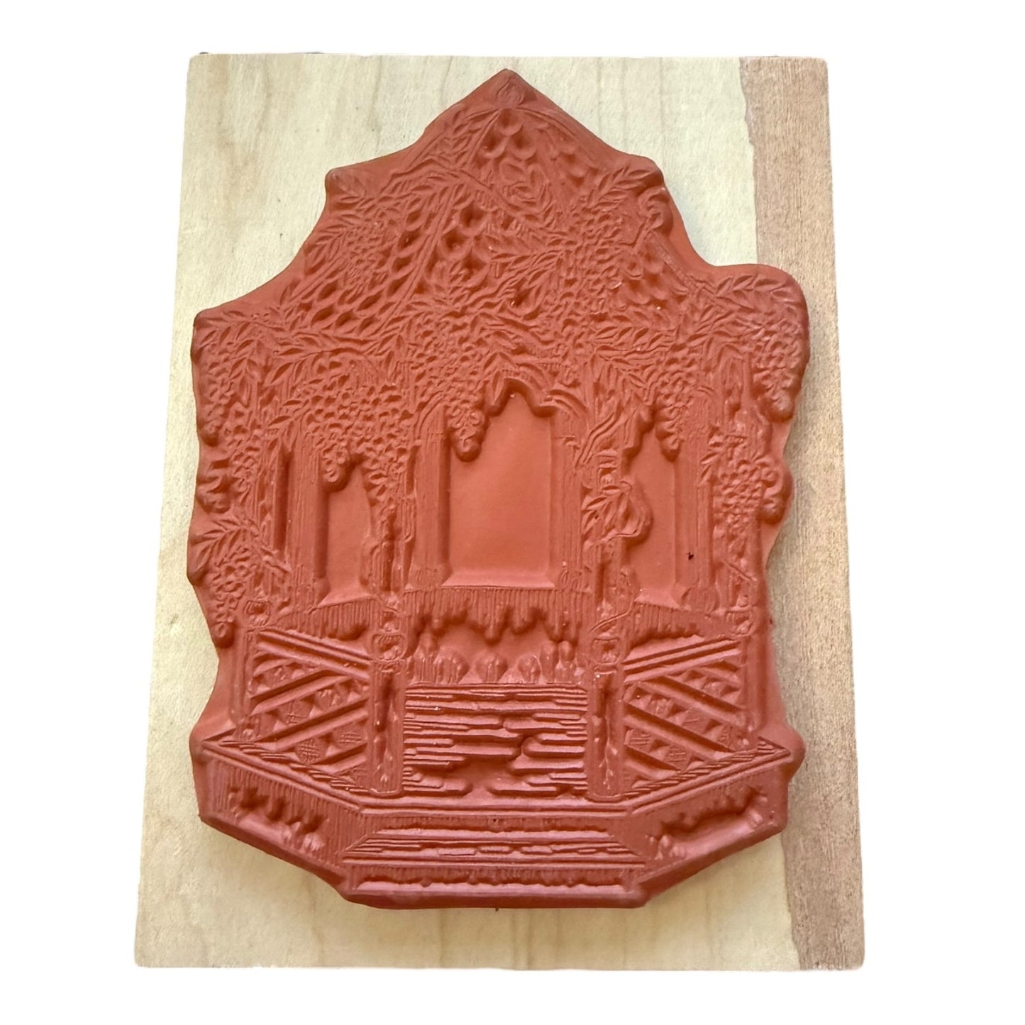 Decorative red rubber stamp on a wooden block