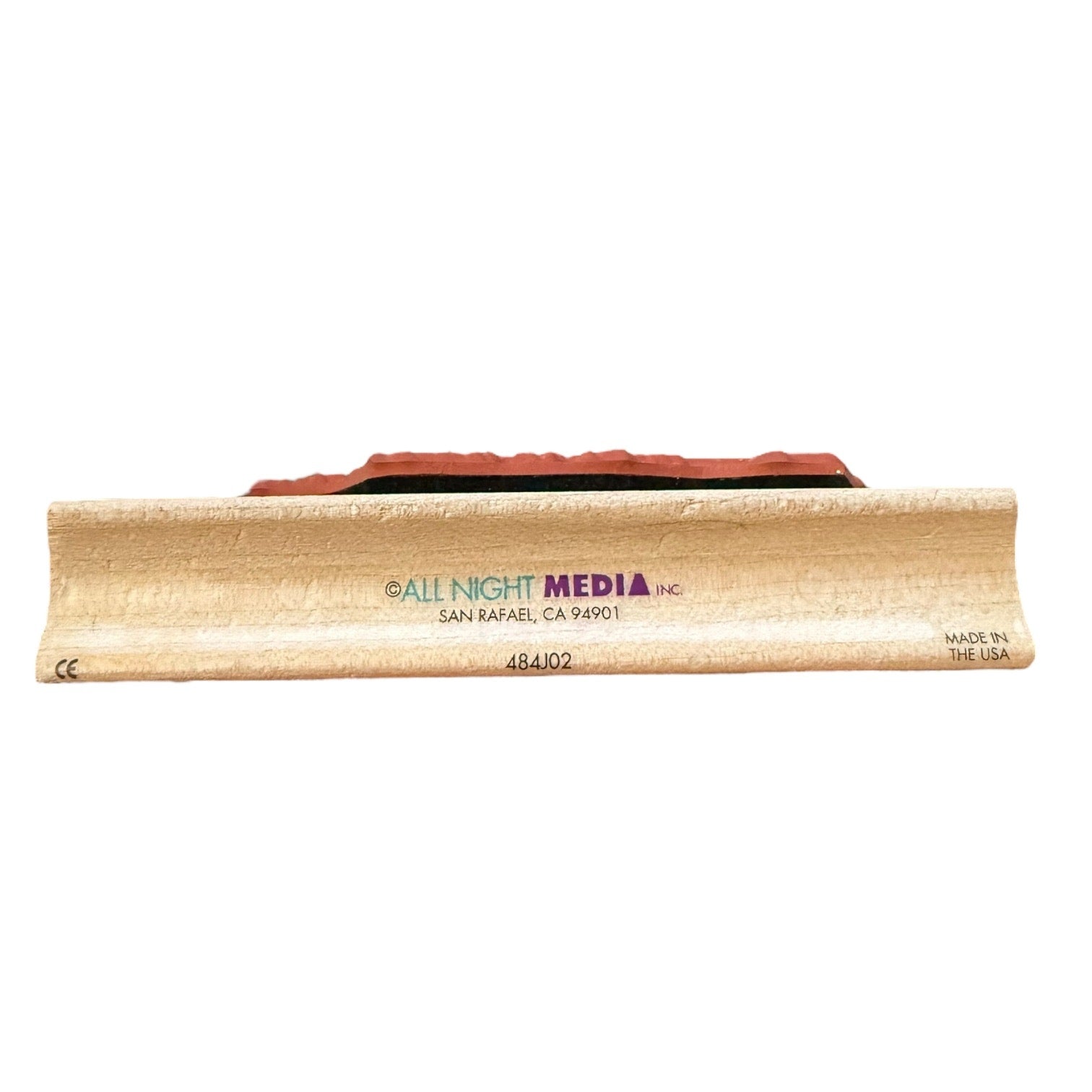 Wooden product with 'All Night Media' branding on a white background