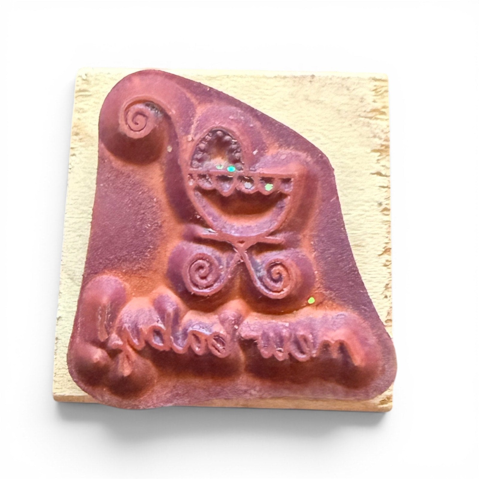 Decorative rubber stamp with a baby carriage design on a wooden block.
