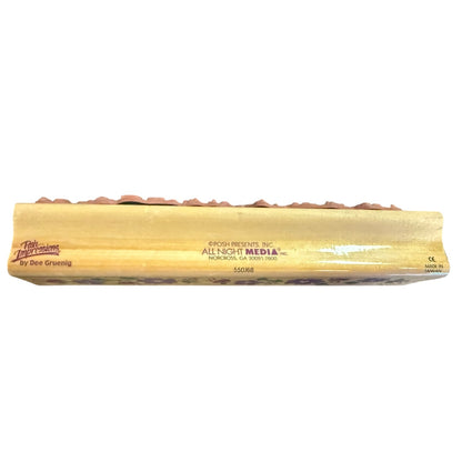 Side view of a wood block for a rubber stamp with a brand name on a white back ground.