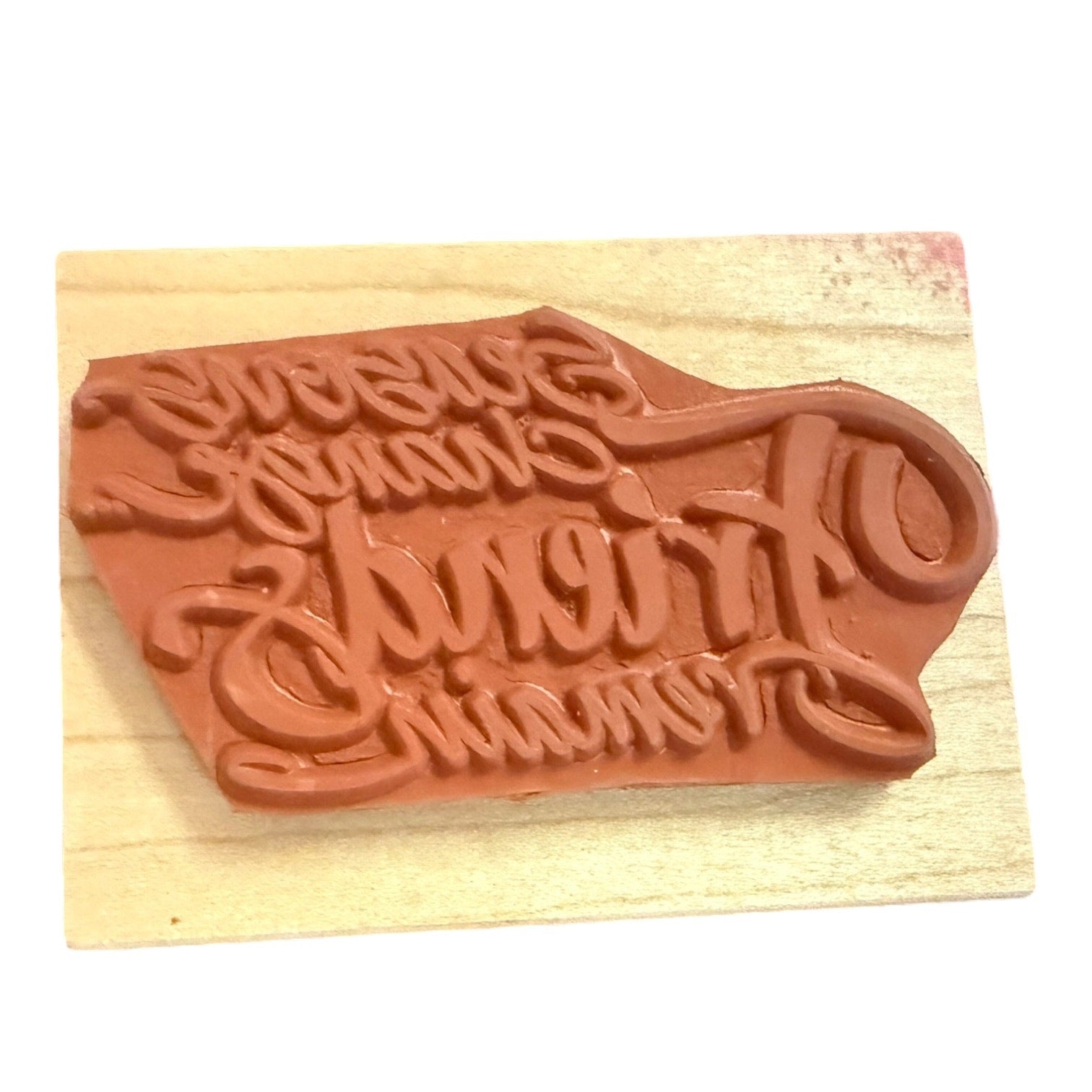 Textured stamp on a wooden block with a white background