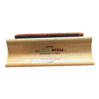 Wooden stamp with 'All Night Media Inc' branding on a white background