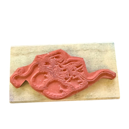 Bottom of stamp on a wooden block with a white background