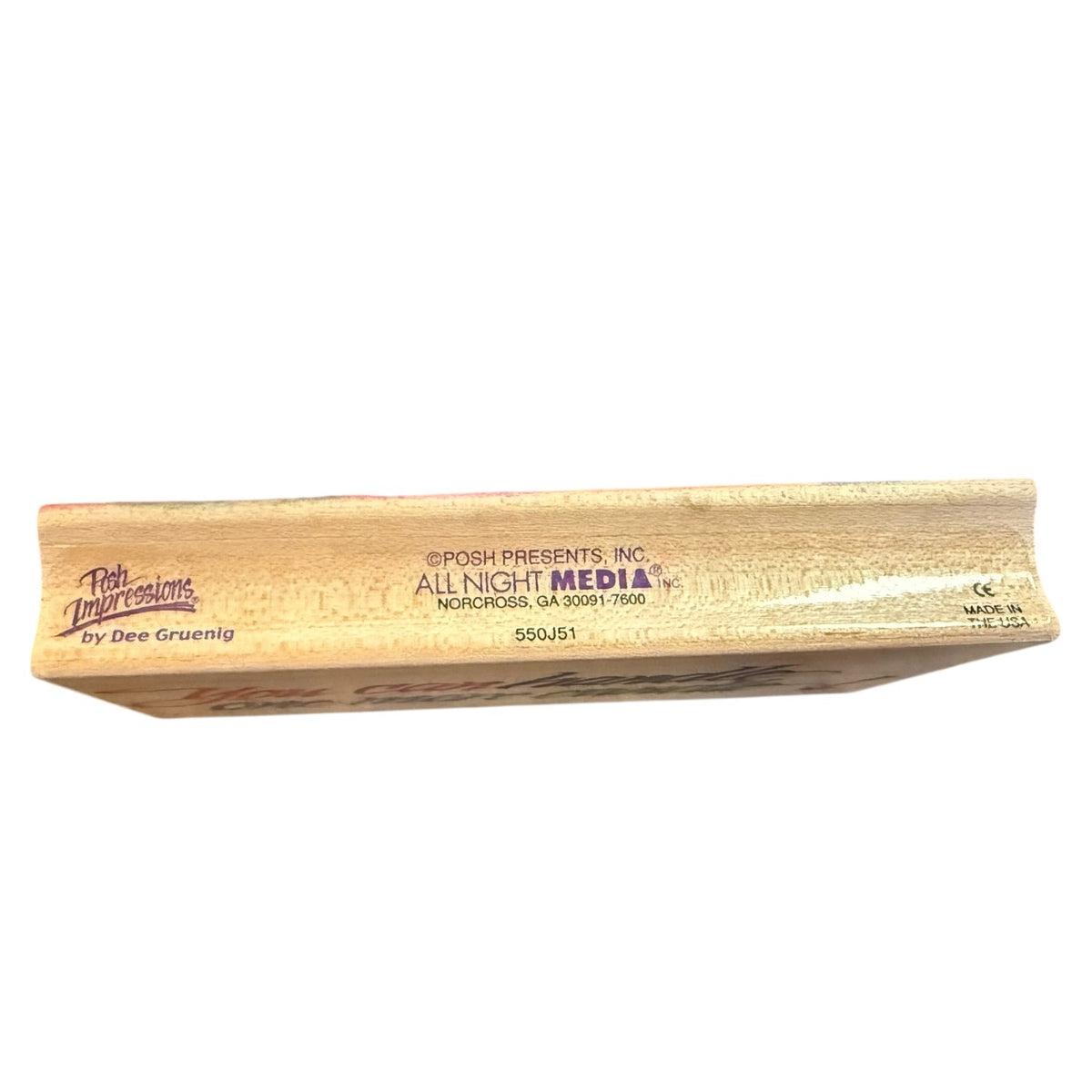 Side view of a wooden stamp with All Night Media info listed on a white background.