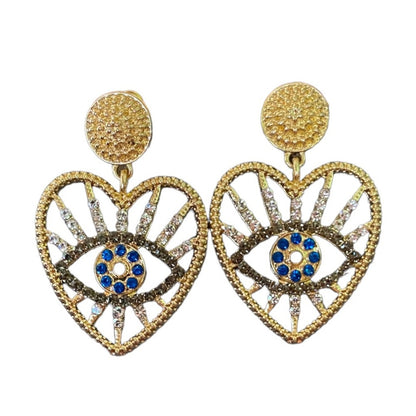 Gold heart-shaped earrings with blue center on a white background