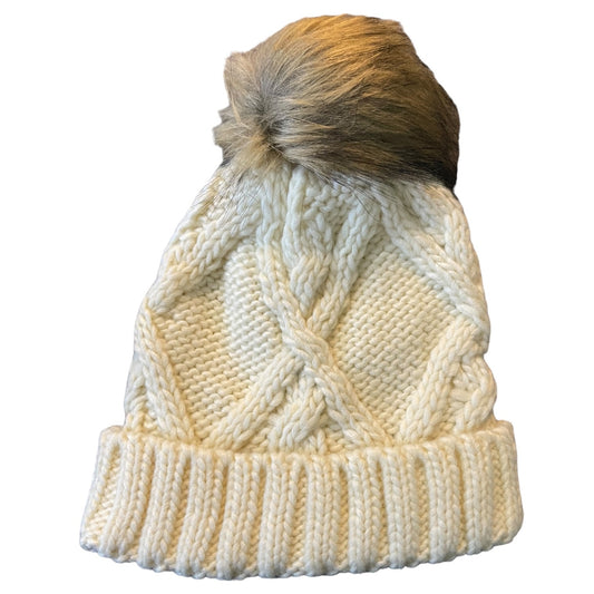 Knitted beanie with a fur pom-pom on a white background