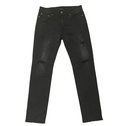 Front of black ripped jeans on a white background