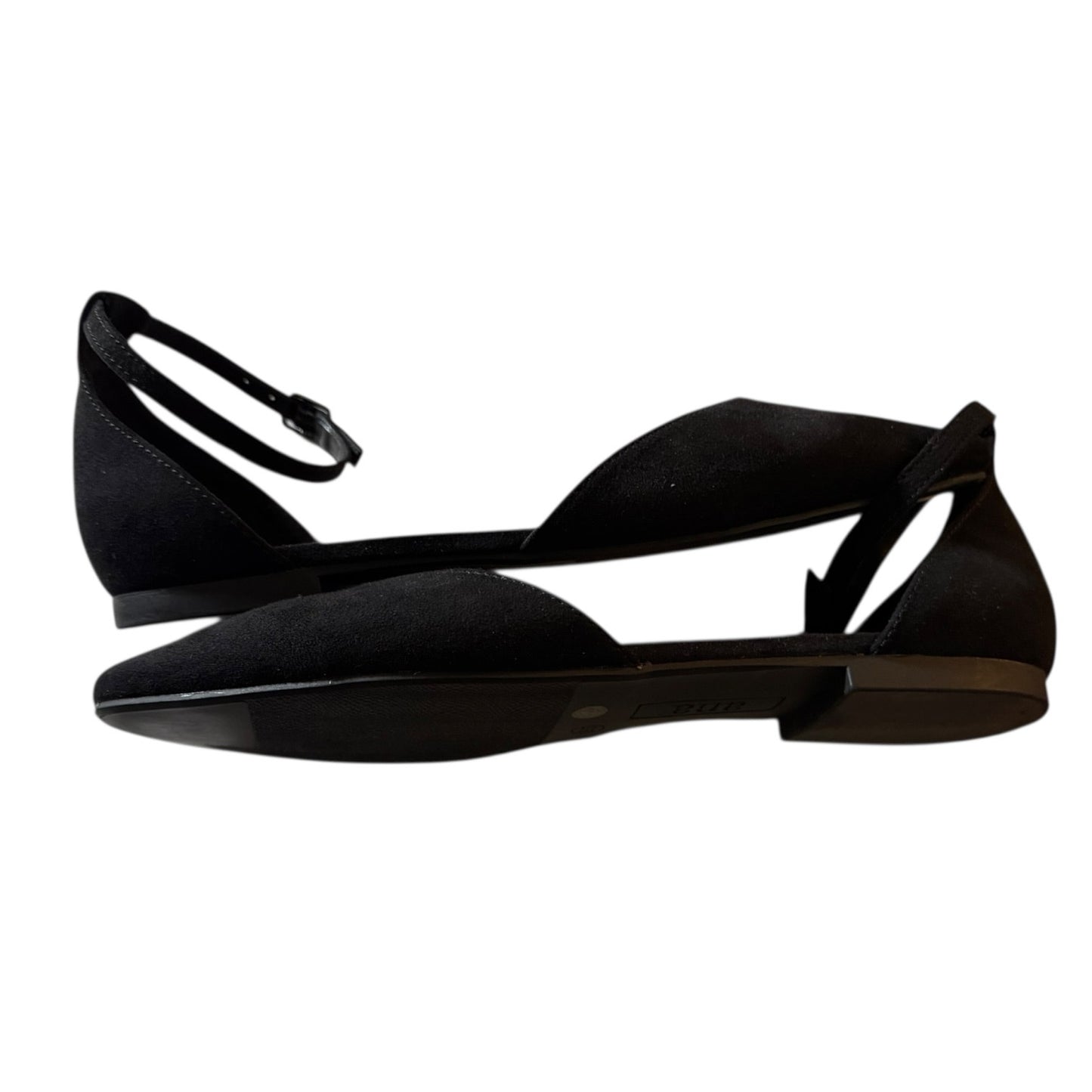 A pair of black flat sandals with a pointed toe, open side straps, and a thin ankle strap with a buckle, shown against a plain white background.