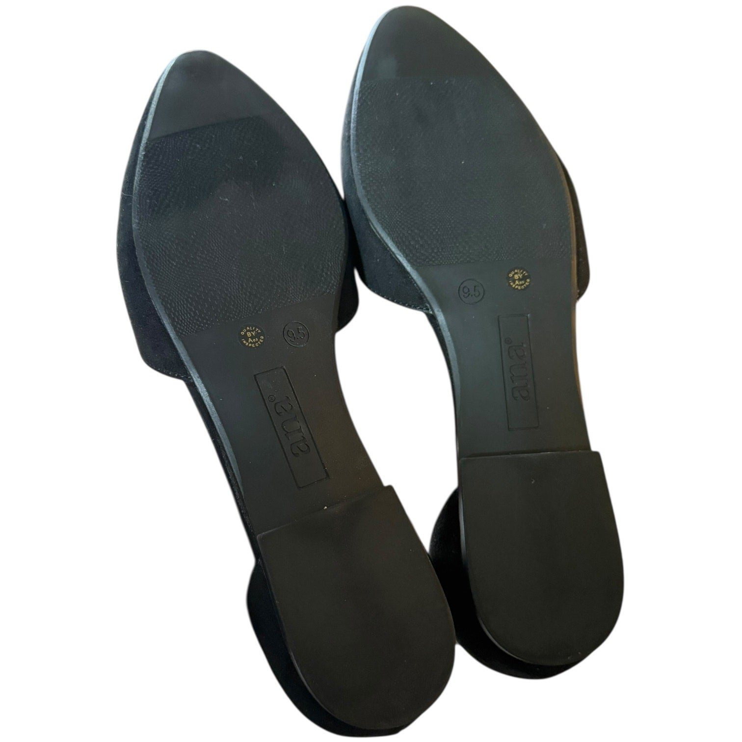 A pair of black pointed-toe flats shown from the sole side, featuring a textured rubber outsole and a low block heel, photographed on a white background.