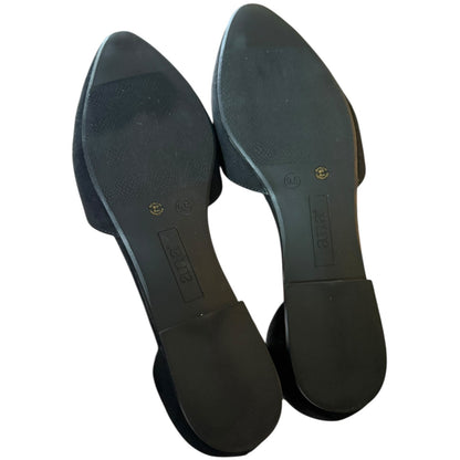 A pair of black pointed-toe flats shown from the sole side, featuring a textured rubber outsole and a low block heel, photographed on a white background.