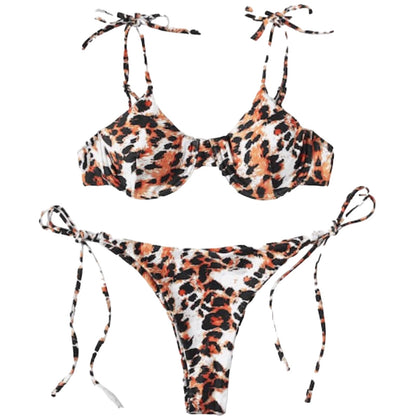 A two-piece bikini set with a leopard print pattern in orange, black, and white. The set includes a bikini top with tie straps and a matching bikini bottom with side ties, displayed on a solid white background.