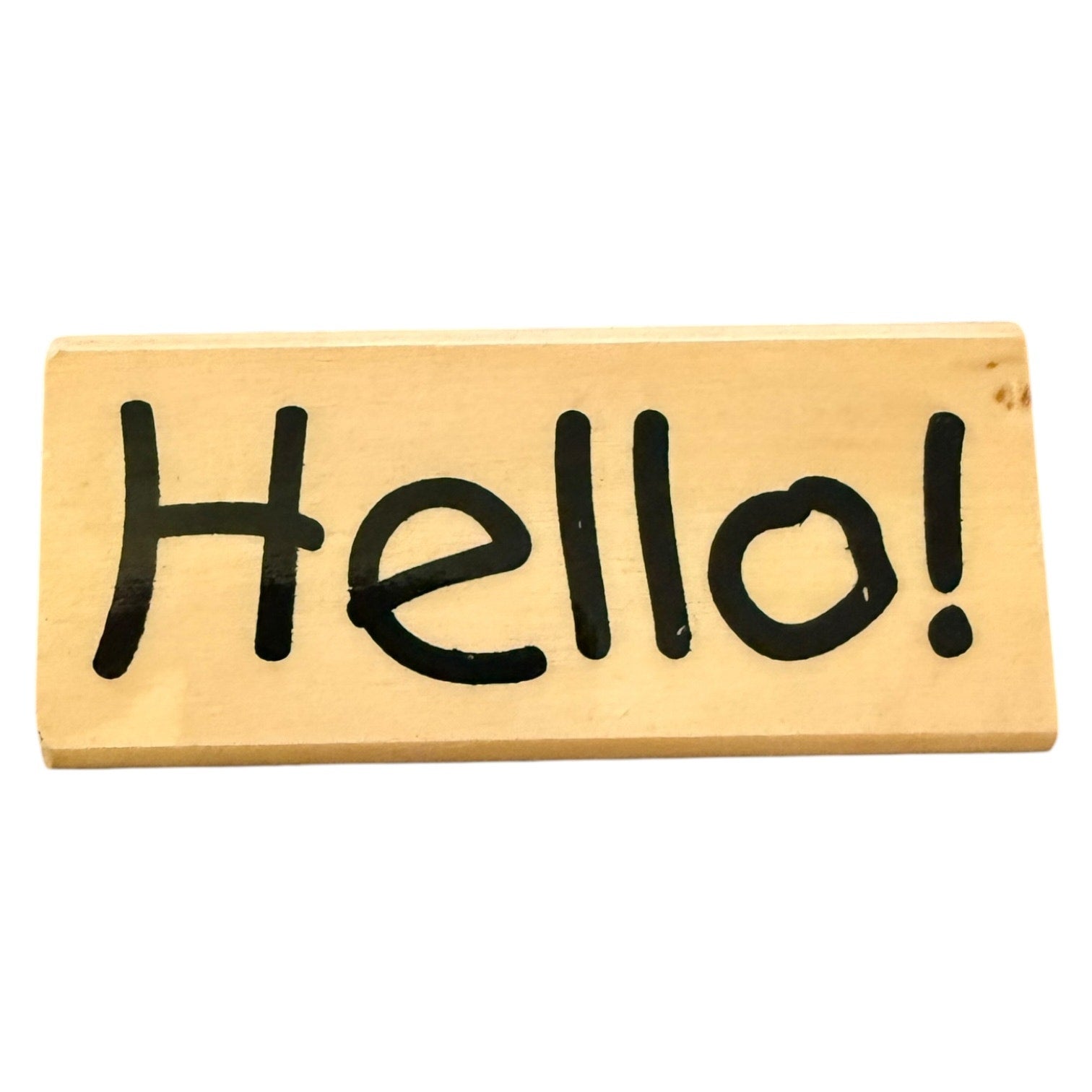 Wooden block with 'Hello!' written in black marker on a white background