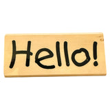 Wooden block with 'Hello!' written in black marker on a white background