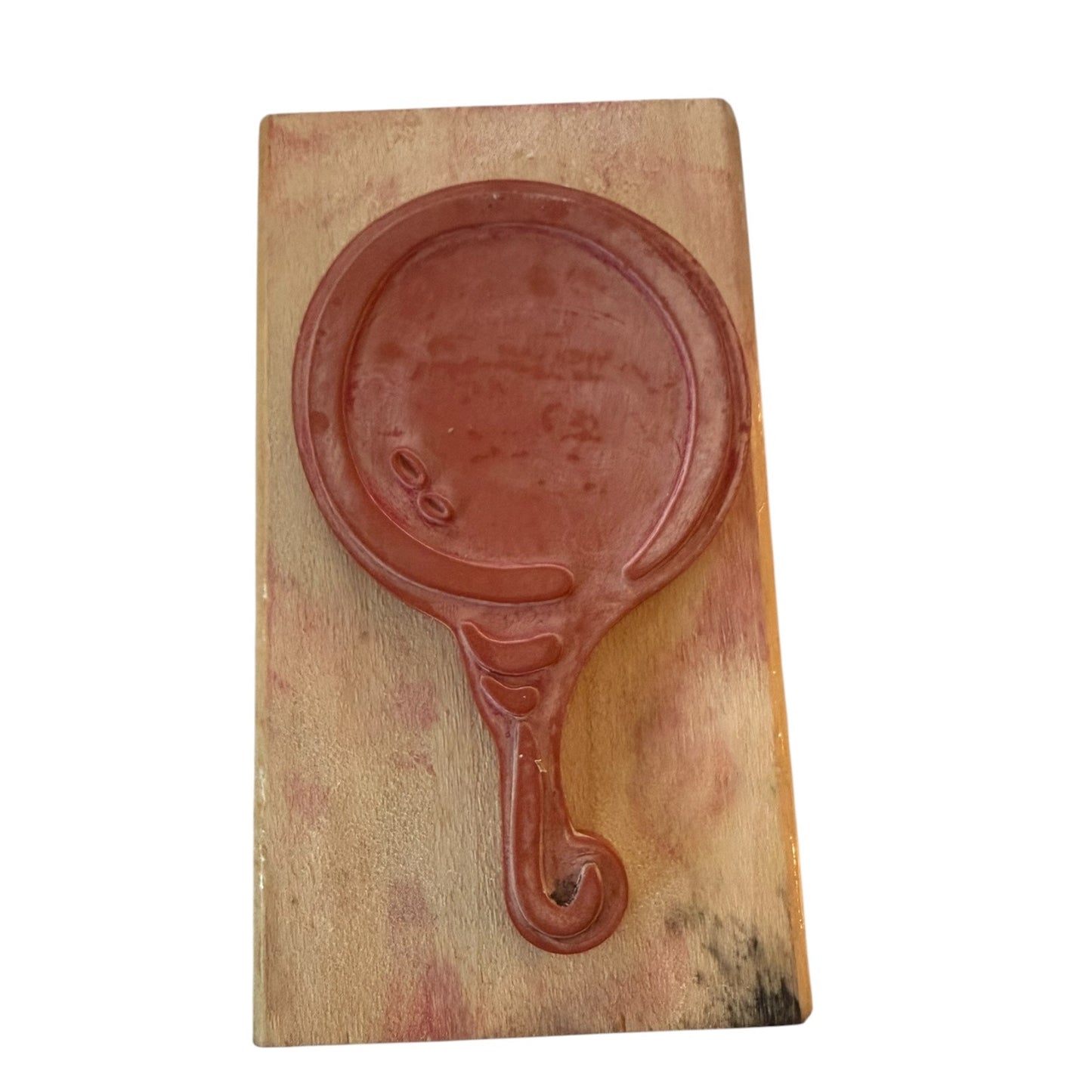 Wood block with a rubber stamp of a balloon, shown against a plain white background.