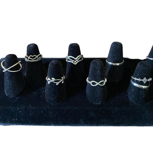 Set of black stackable rings in an assortment of designs on a white background