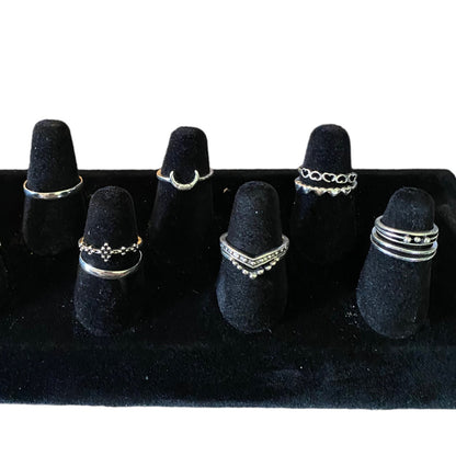 Set of silver stackable rings in an assortment of styles on a display