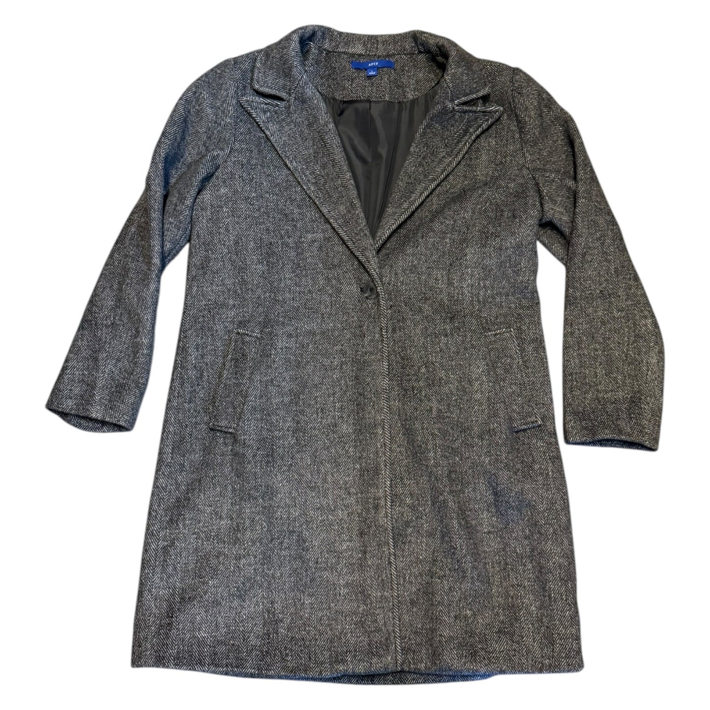 Overcoat laying flat on the ground with a white back ground