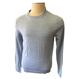 Front of blue sweater on a mannequin against a white background