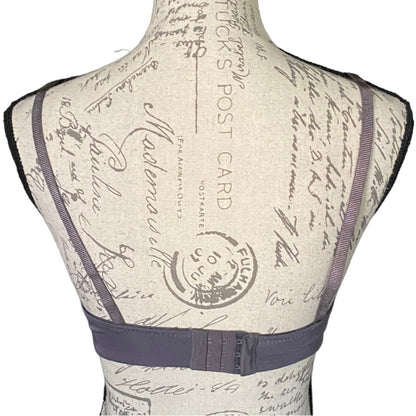 Back of purple bra on a mannequin on a white background