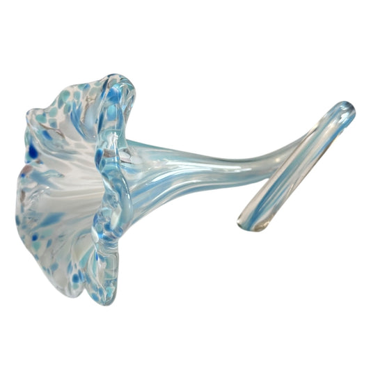Glass sculpture of a flower with blue and white patterns on a white background